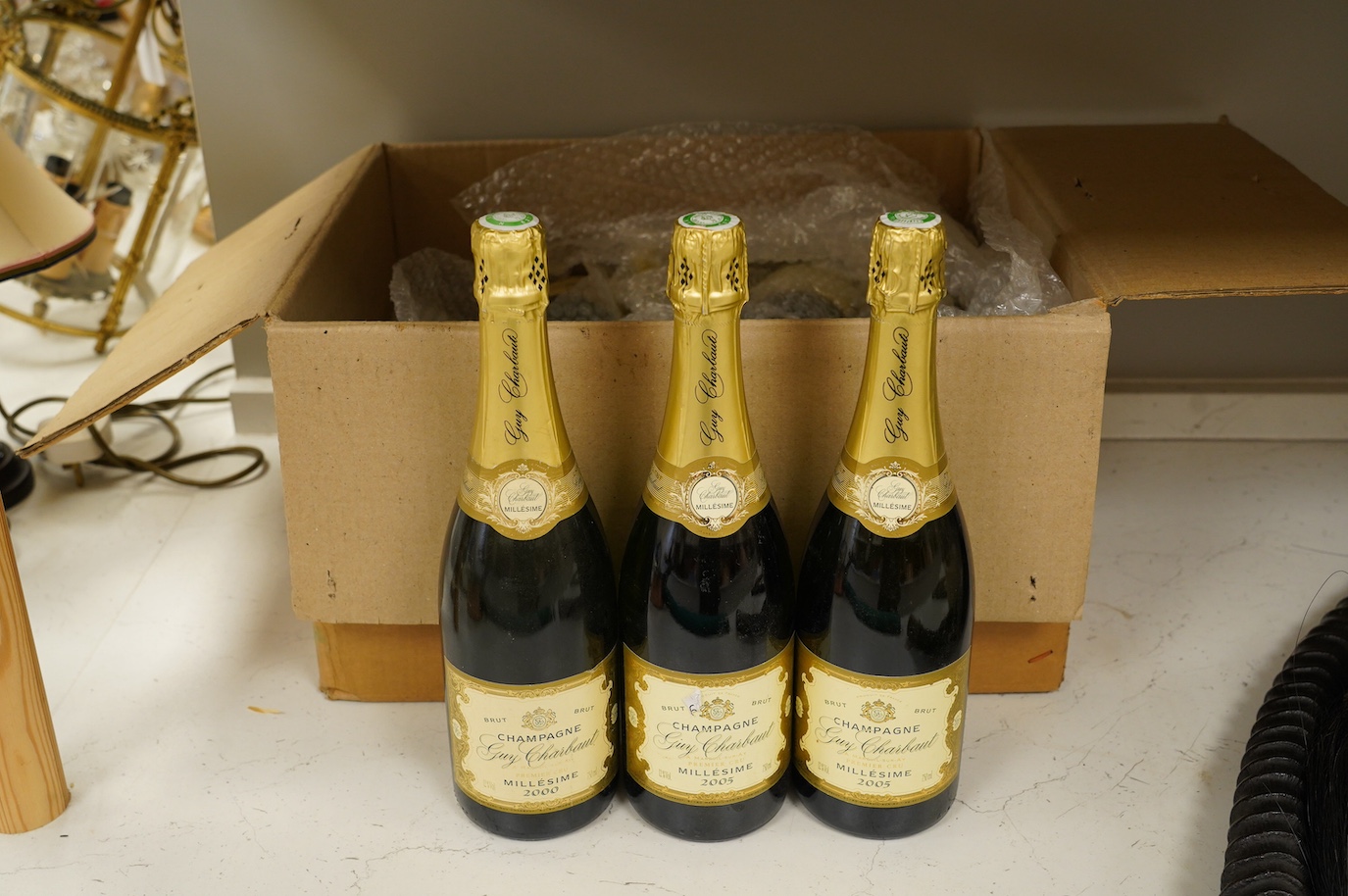 Twelve bottles of Guy Charbaut champagne (8 x 2000 and 4 x 2005). Condition - good